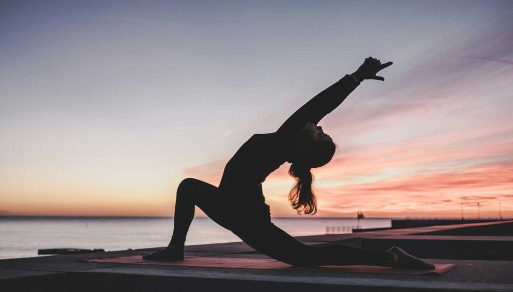 A person meditating after a workout at the gym, exuding calm and relaxation.
