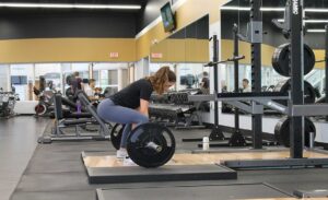 People engaged in gym workouts, including weightlifting, running, and yoga, showcasing the physical and mental benefits of regular exercise.