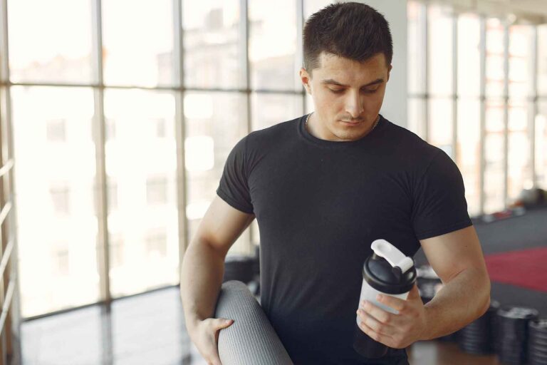 Man considering the Pre-Workout Supplements Affect Male Fertility, with healthy food options nearby.